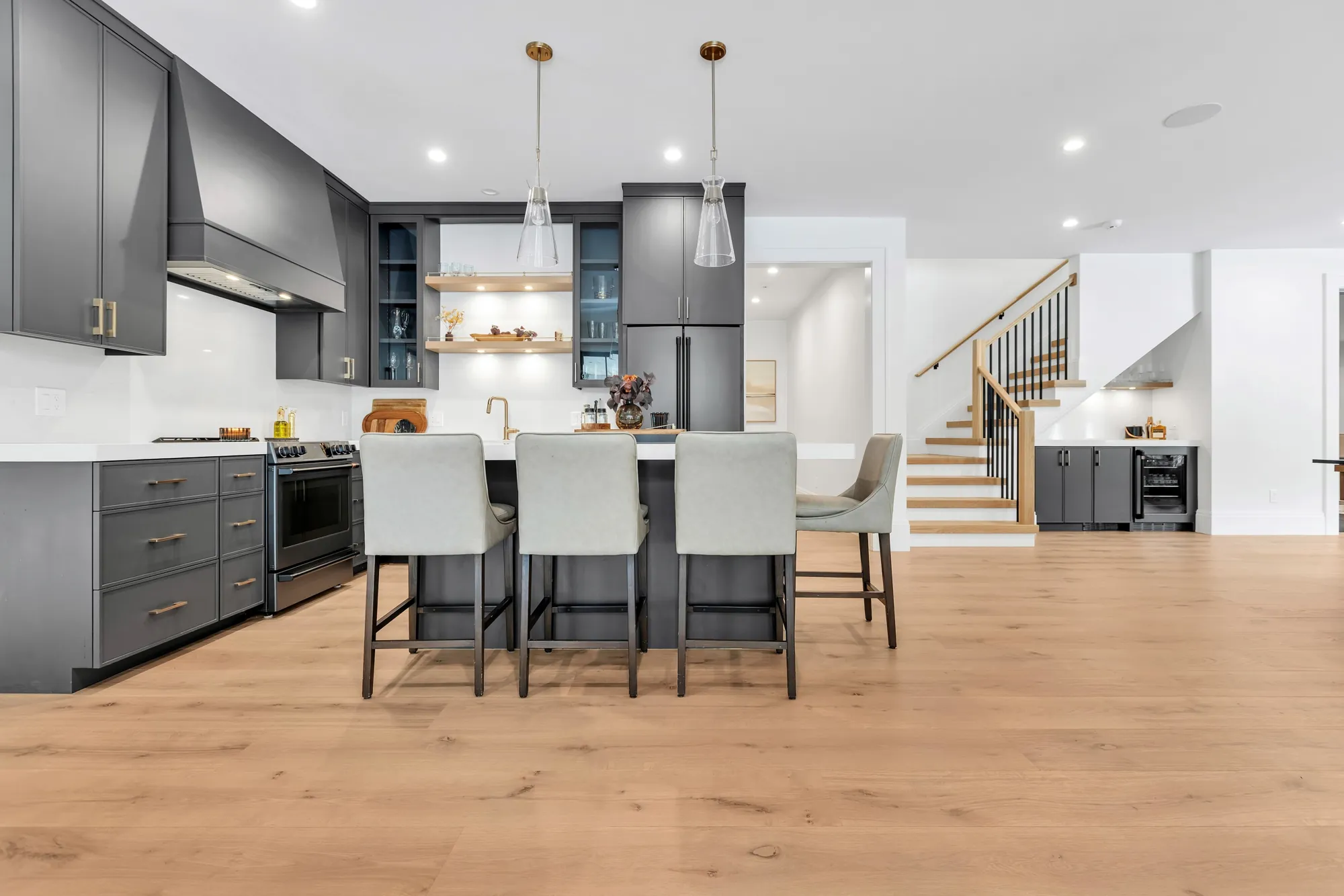 Light oak floor in a gray kitchen with an island